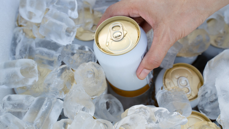 Cold cans in iced cooler.