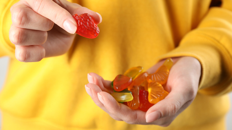 Person holding a handful of fruit snacks