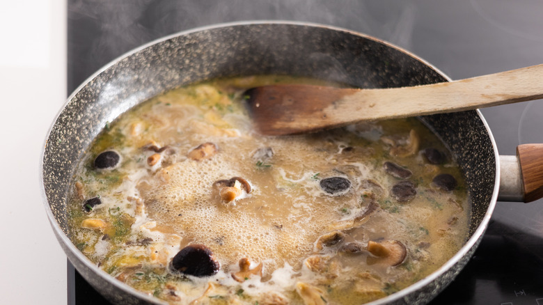 Mushrooms cooking in pan