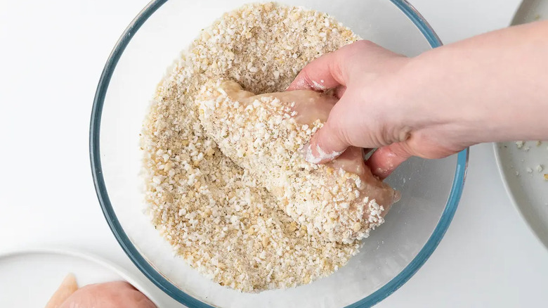 Breading chicken Parmesan in bowl