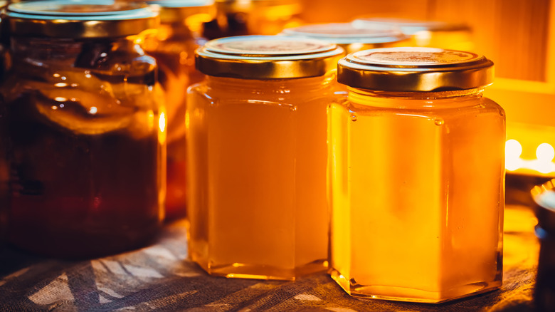 A small handful of honey jars lined up