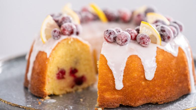 A cranberry bundt cake with sugared cranberries on top