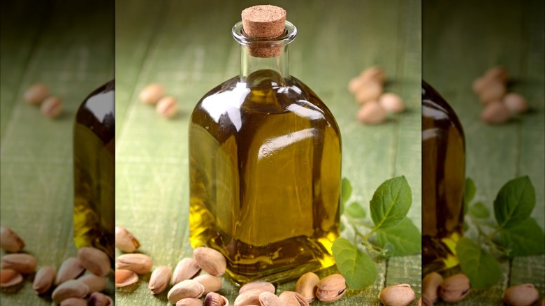 Bottle of pistachio oil with whole pistachios