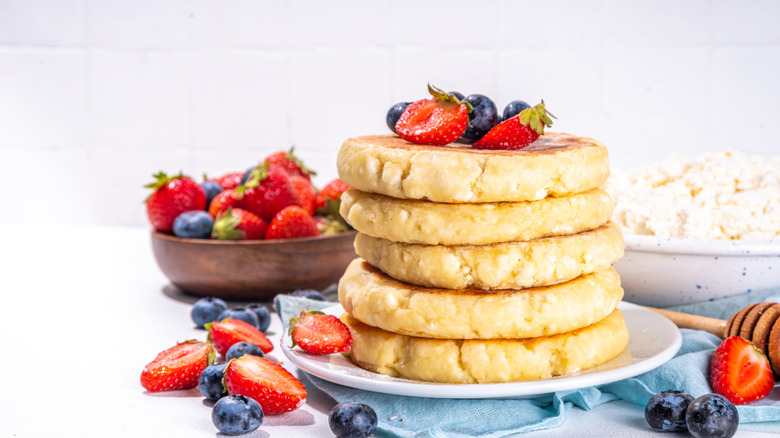 A stack of protein pancakes topped with berries