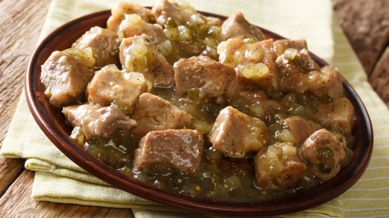 plate of pork chunks in chili verde sauce