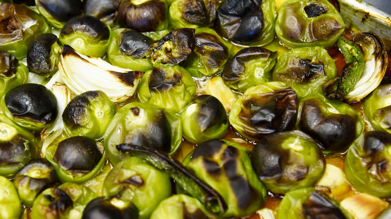 Sheet pan of charred, roasted tomatillos and onions