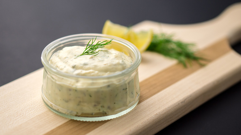 tartar sauce in a jar on a wooden board