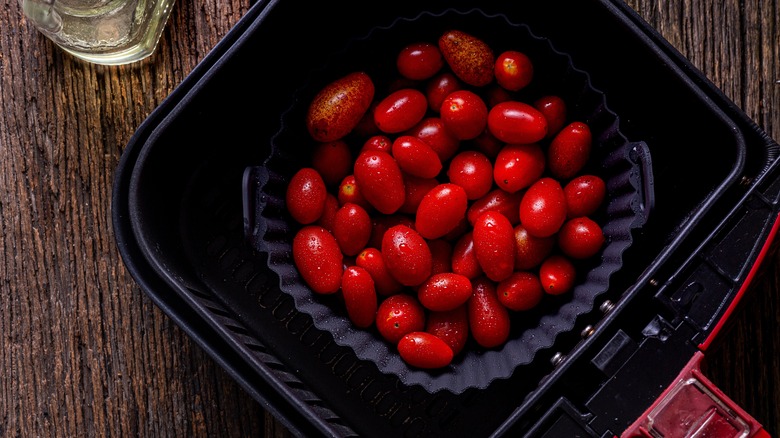 grape tomatoes in an air fryer basket