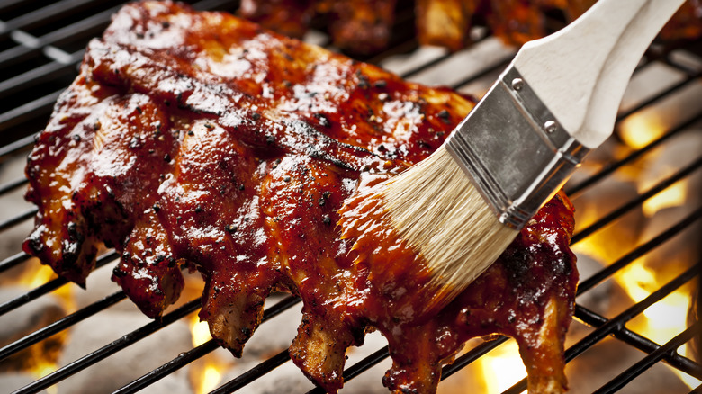 Glazing baby back ribs on the grill