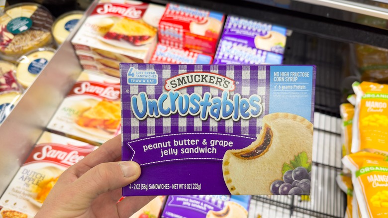 shopper holding Uncrustables package