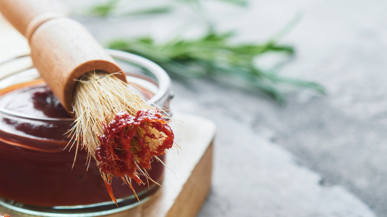 Bowl of barbecue sauce with brush