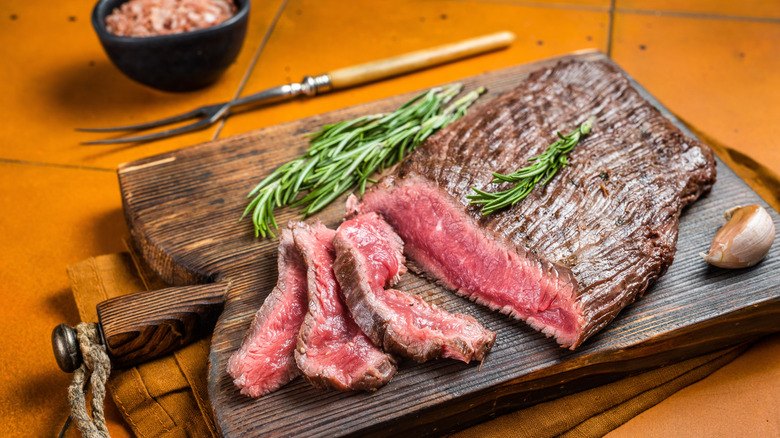 flap steak sliced on wooden board