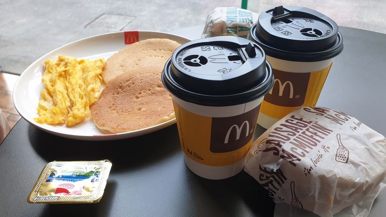 Mcdonald's breakfast with eggs, pancakes, and coffee