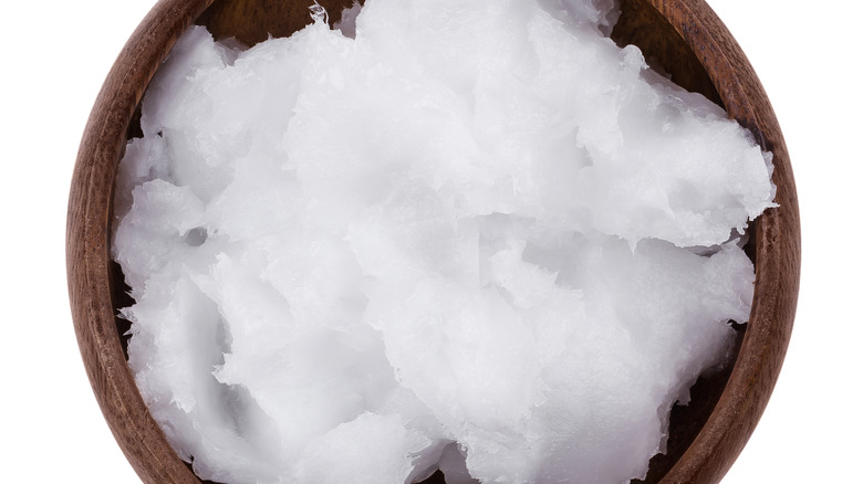 solid coconut oil in a wooden bowl