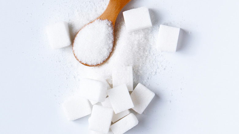 white sugar cubes and spoonful