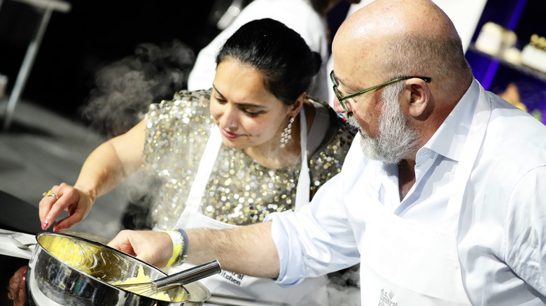Maneet Chauhan and Andrew Zimmern cooking