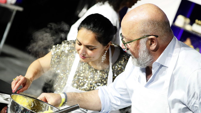 Maneet Chauhan and Andrew Zimmern cooking