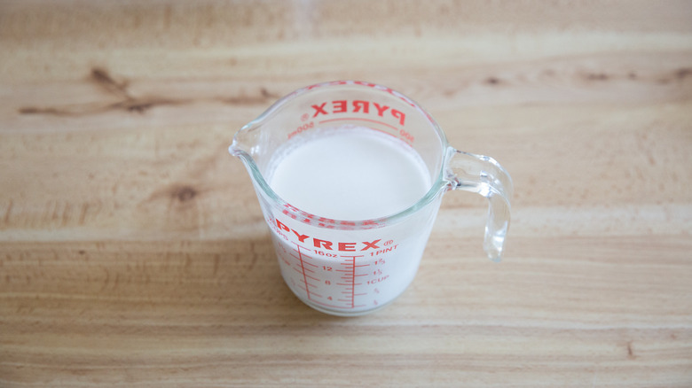 coconut milk in measuring cup 