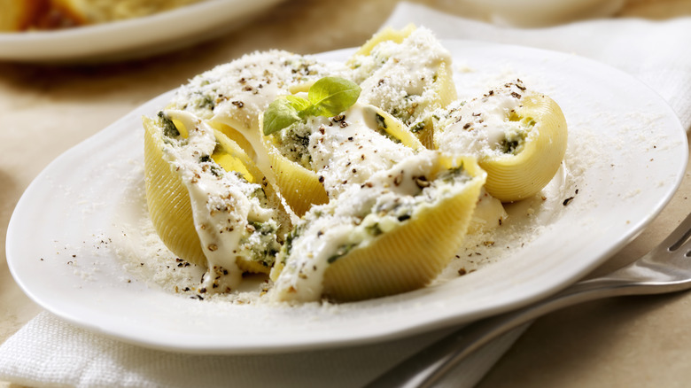 Stuffed shells with ricotta and spinach on a white plate