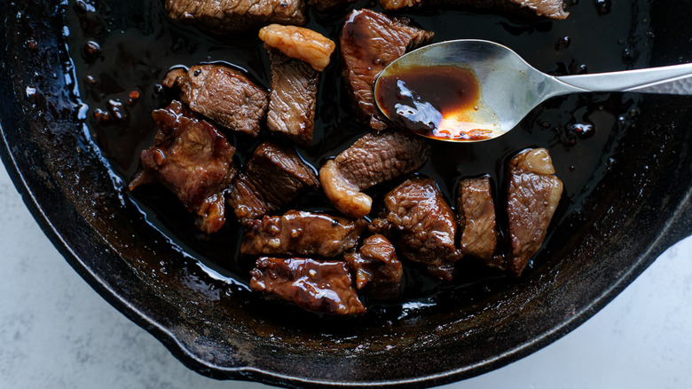 basting steak tips in skillet