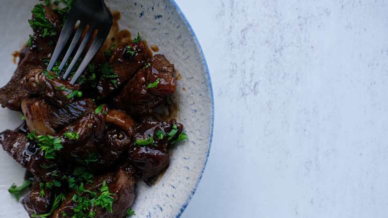 garnished steak tips in bowl