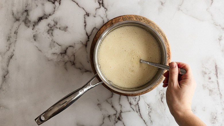 Stirring baking soda into saucepan