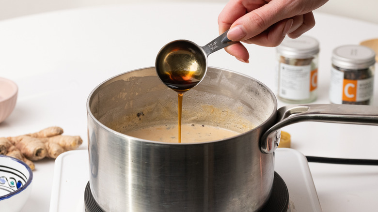 pouring maple syrup into saucepan