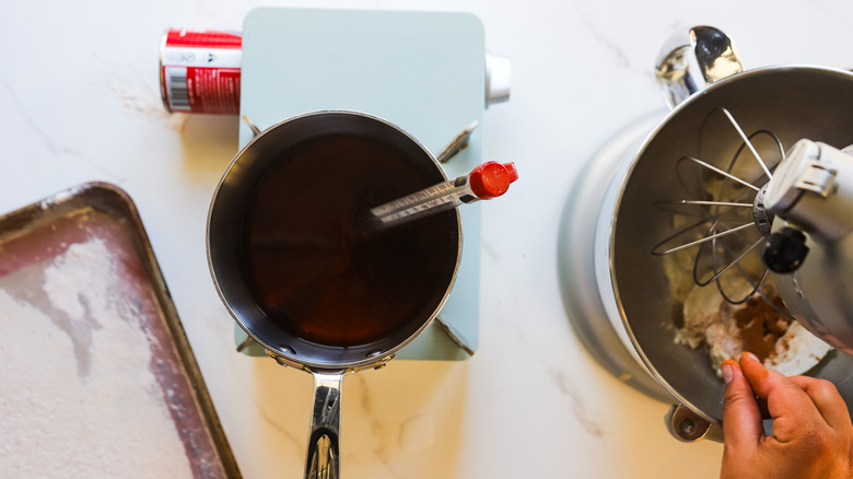 Hand adding cinnamon to bowl