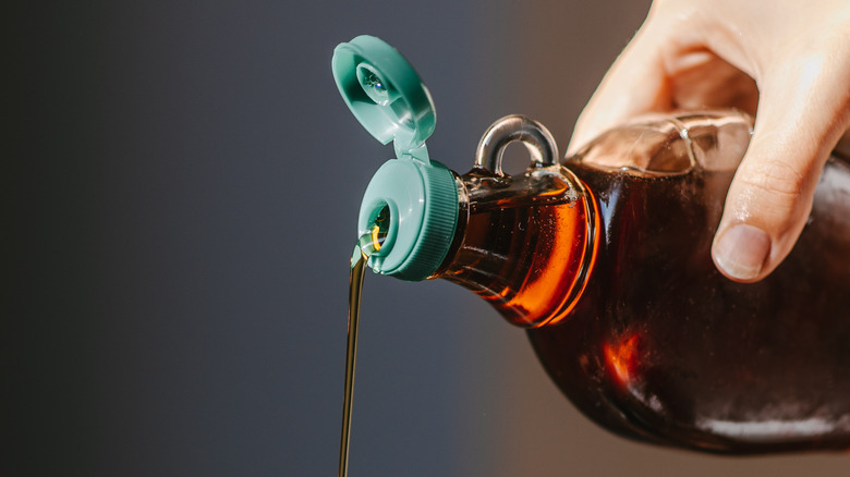 Pouring bottle of maple syrup