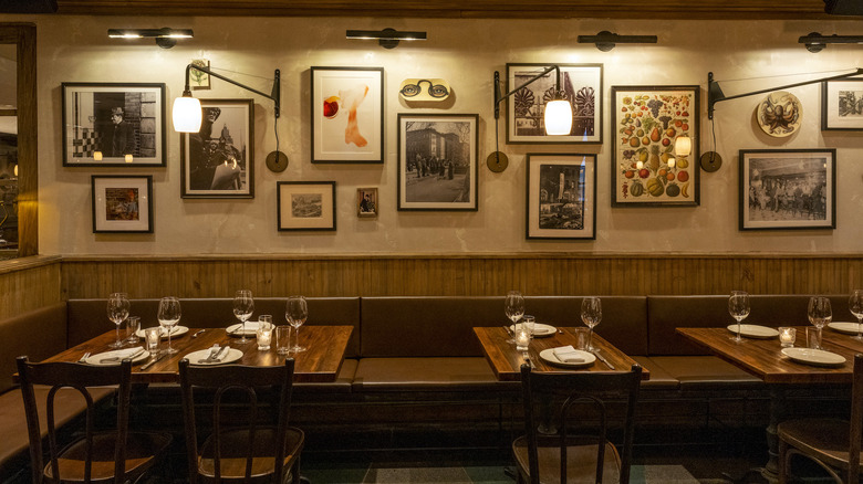 One Fifth interior with dining tables and framed photos hung on wall