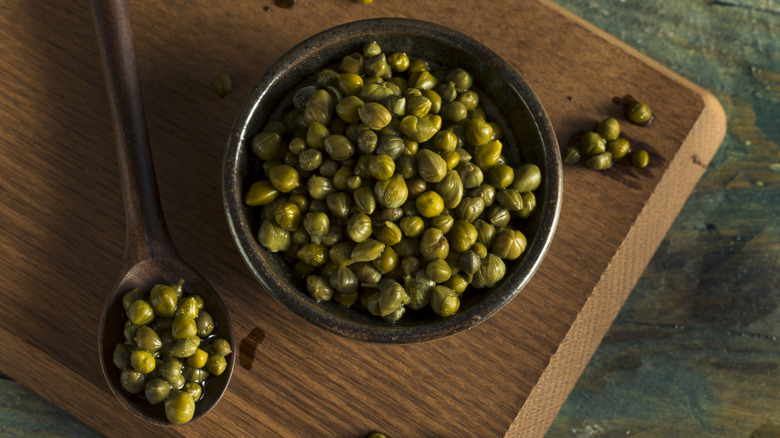 capers in bowl, on spoon, and on platter