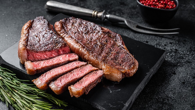 Steak sliced on cutting board