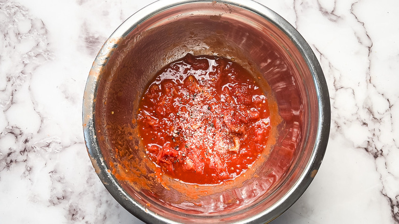 Crushed seasoned tomatoes in bowl