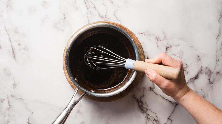 Whisking balsamic vinegar in saucepan