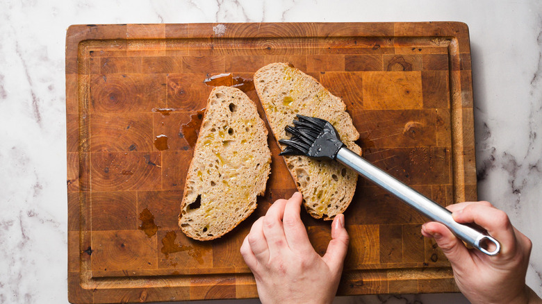 Pastry brush brushing oil onto bread