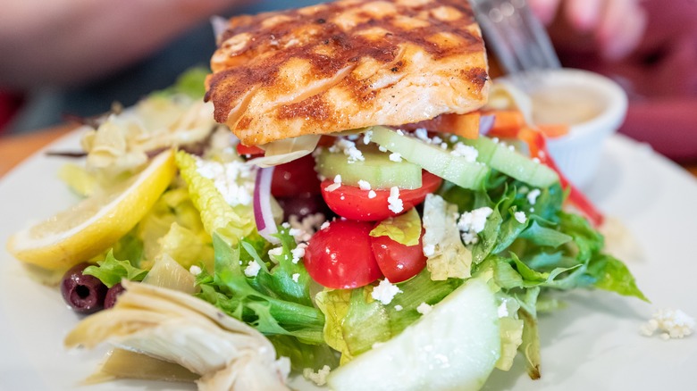 salmon over a Greek salad