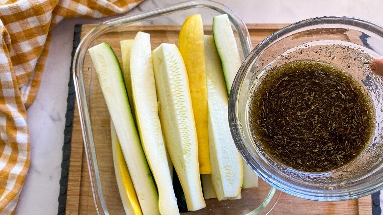 pouring marinade on squash