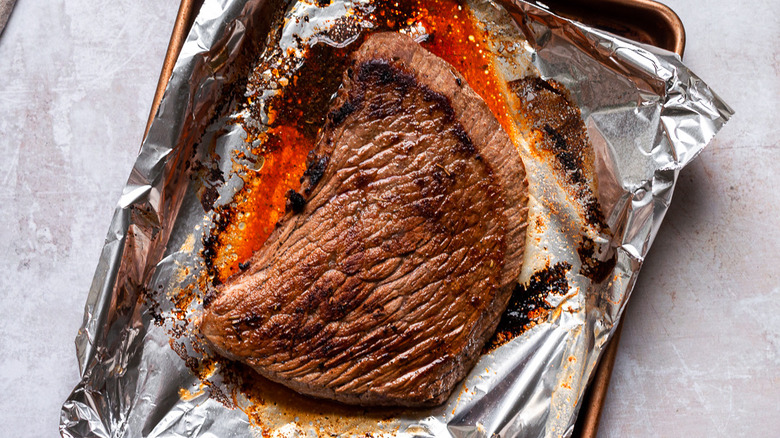 broiled steak on foil