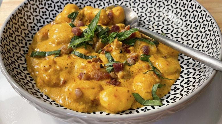 pancetta tomato gnocchi with basil in bowl