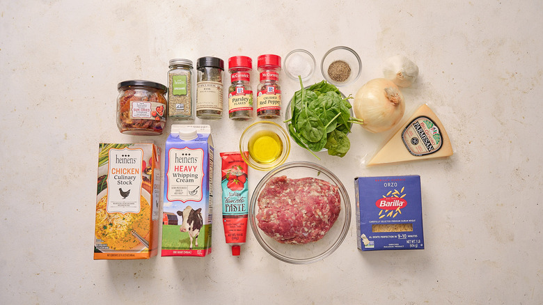 Ingredients for sausage orzo soup on a table