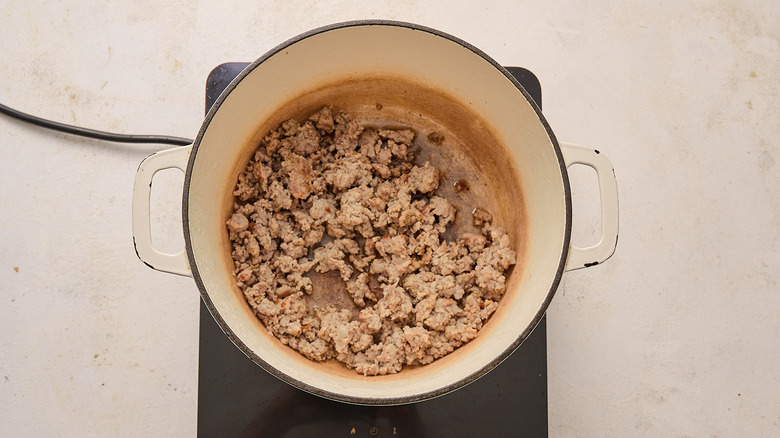 Sausage cooking in a Dutch oven