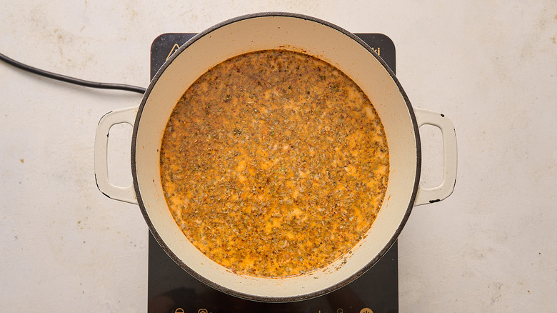 Seasoned soup broth in a Dutch oven