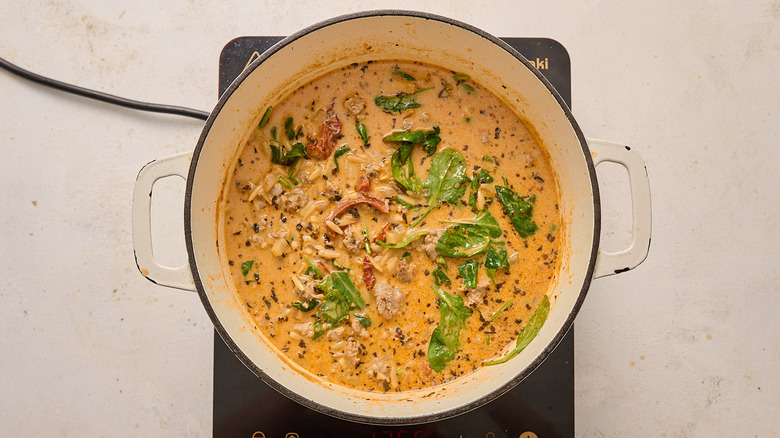 A soup simmering in a Dutch oven