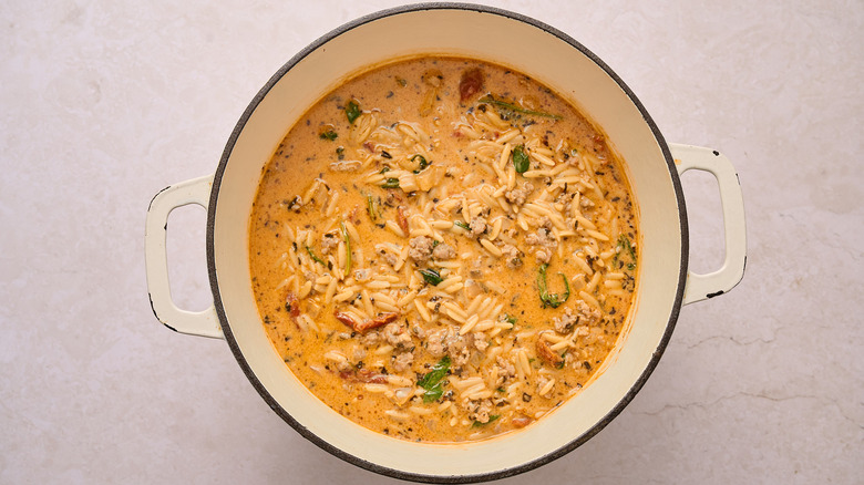 Orzo and sausage soup in a Dutch oven