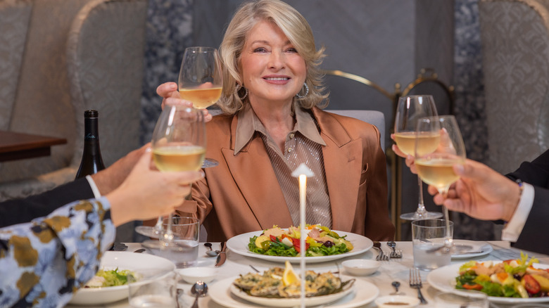 Martha Stewart toasting dinner guests