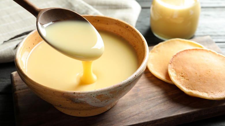 spoonful of condensed milk from yellow bowl