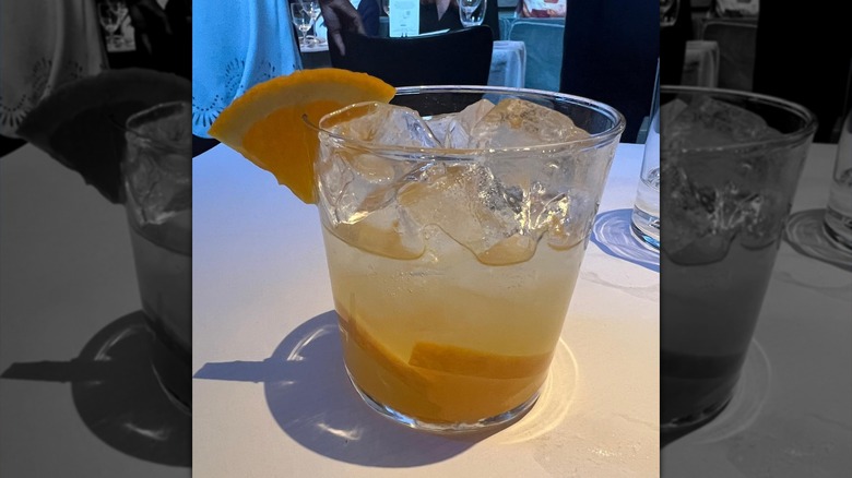 Martha Stewart's cointreau kiss cocktail, with a slice of orange on the glass