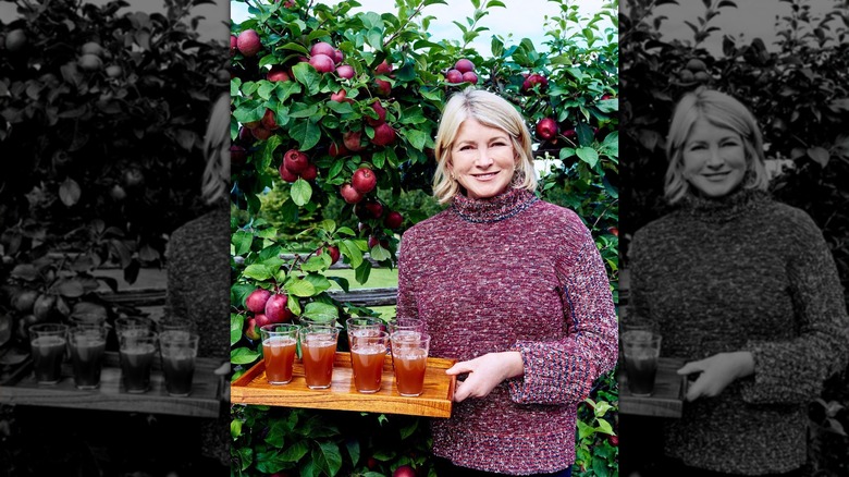 Martha Stewart holding a tray of her homemade apple cider