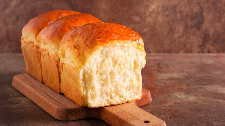 Japanese milk bread loaf on cutting board