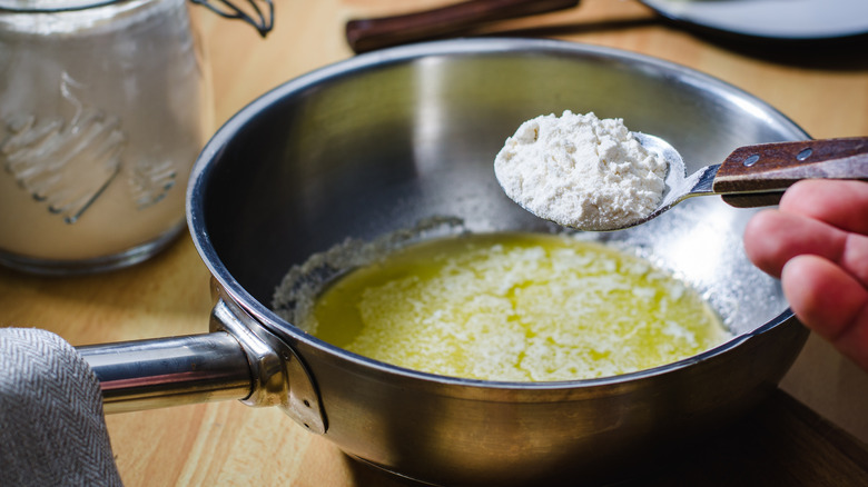 flour spoonful going in pot